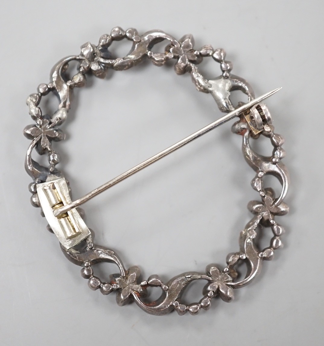 A 19th century white metal rose cut diamond and ruby set open work oval wreath brooch, 44mm.
